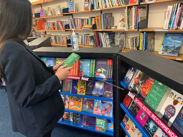 A student browsing the Scholastic Book Fair in November